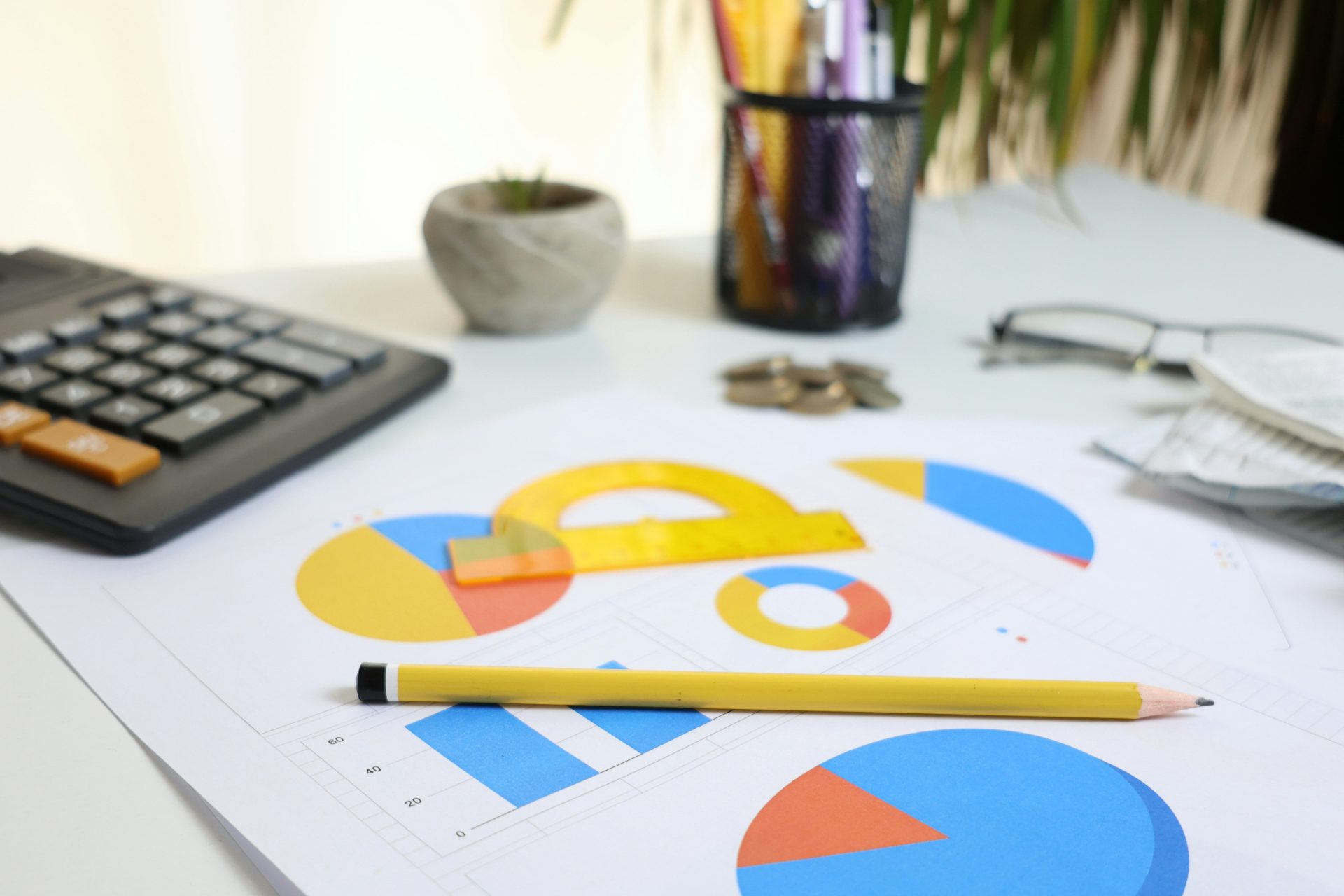 Desk with calculator, charts, and pencil